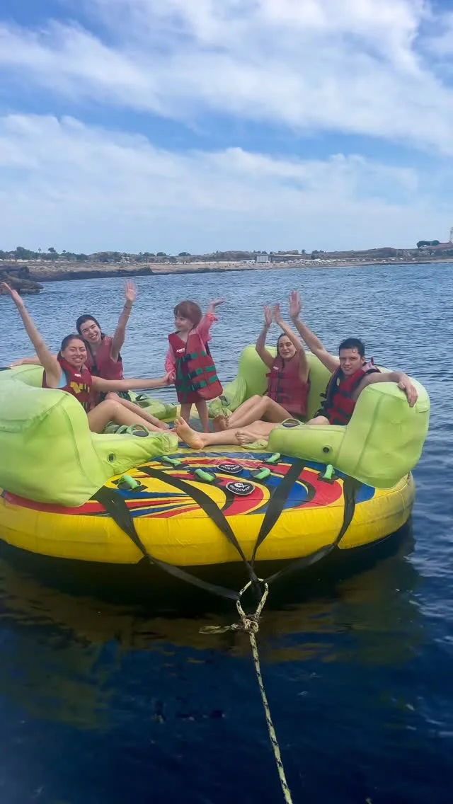 A real Zens ringo ride: guests in life jackets cheering on the inflatable